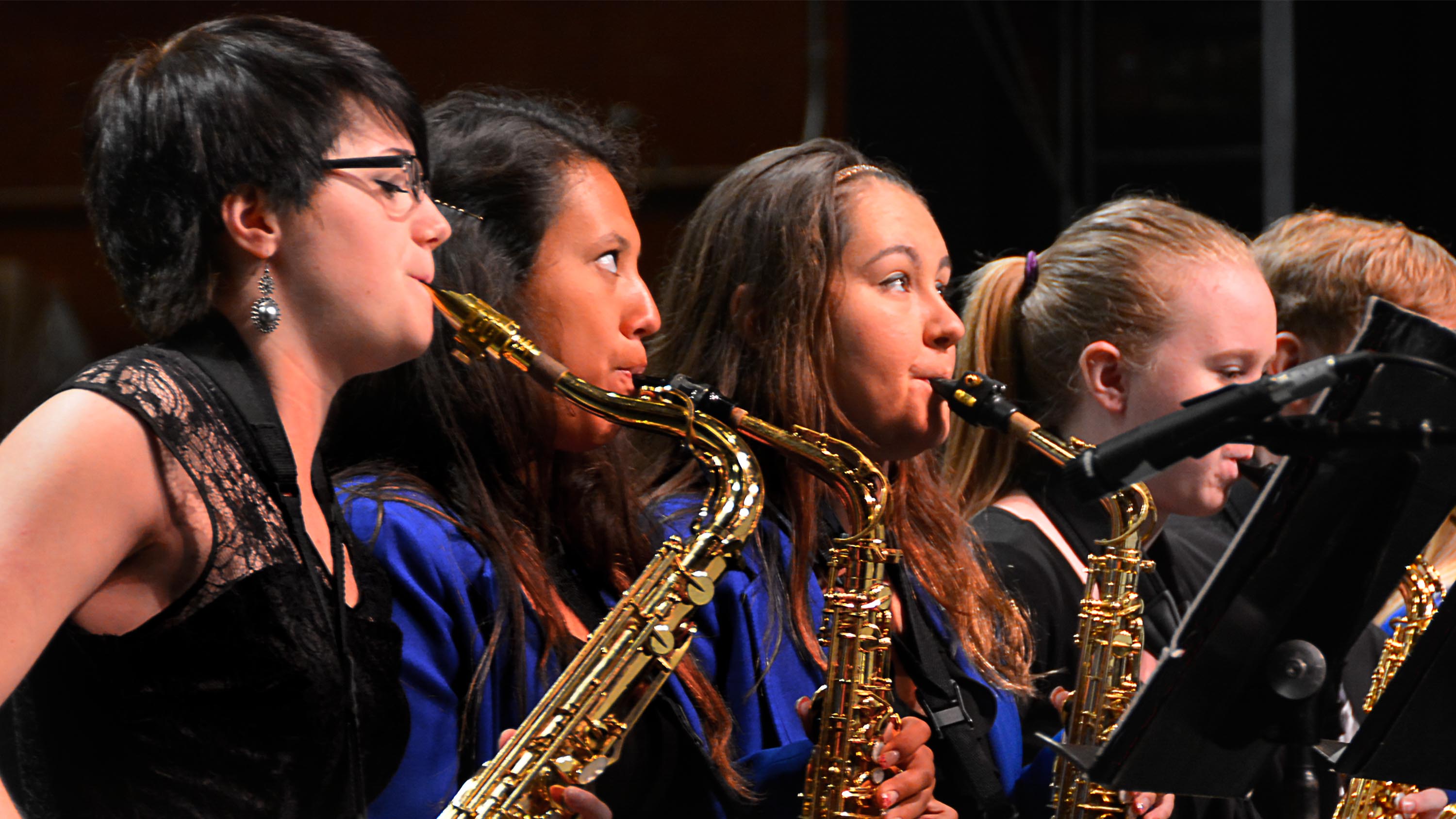 Students playing saxaphone band instrumental festivals