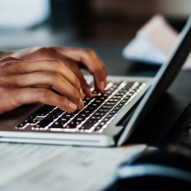 Close Up Of Man Typing On Laptop