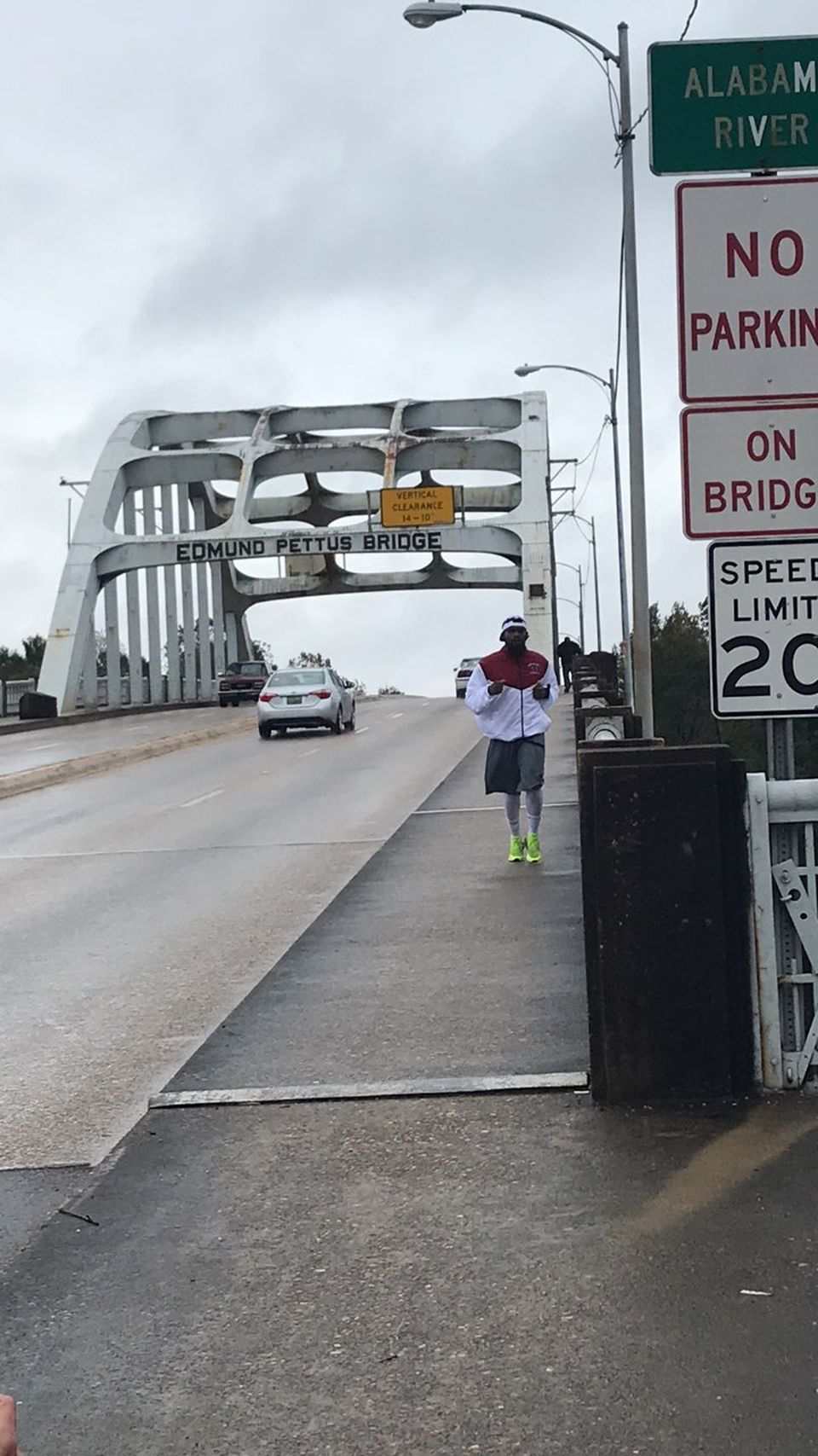 a teacher runs across an Alabama bridge to help students