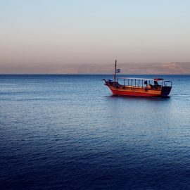 Boat in sunset Sea of Galilee near Capernaum, Isra