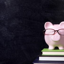 Piggybank with glasses and blackboard
