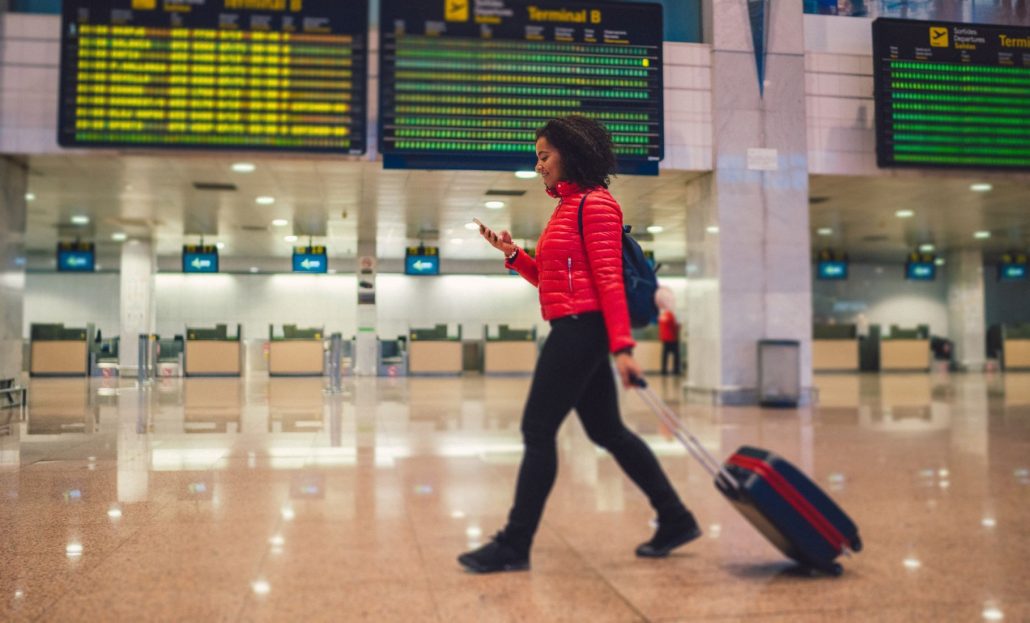 Young woman walking through the airport terminal