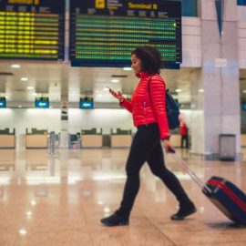 Young woman walking through the airport terminal