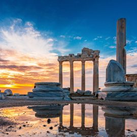 Dramatic sunset over the Temple of Apollo in the Antayla Province