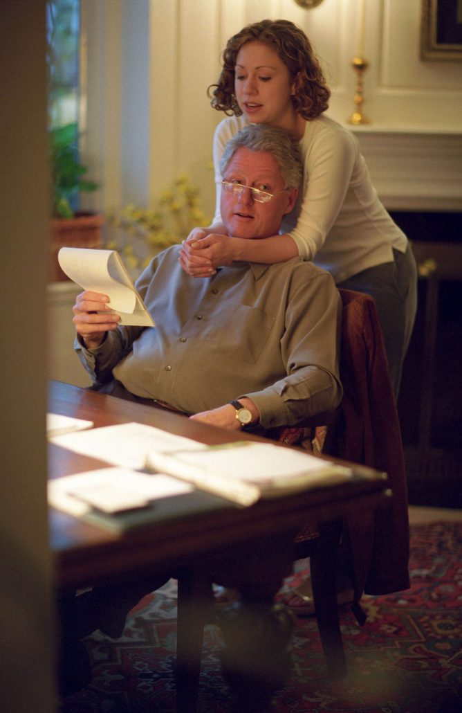 This item is a photograph of President William Jefferson Clinton and Chelsea Clinton in the study of the Chappaqua Residence in Chappaqua, New York. Chelsea Clinton embraces President Clinton. The image was photographed by David Scull.