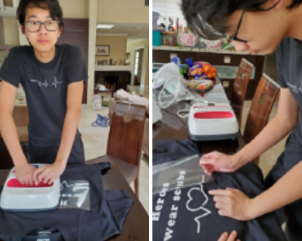 Teenage boy printing designs onto t-shirts