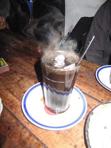 Kopi Joss - Coffee with steaming coal placed in the cup 