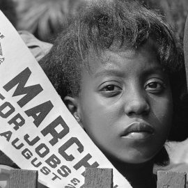 Young Woman holds a banner at Civil Rights March on Washington, D.C. on August 28, 1963