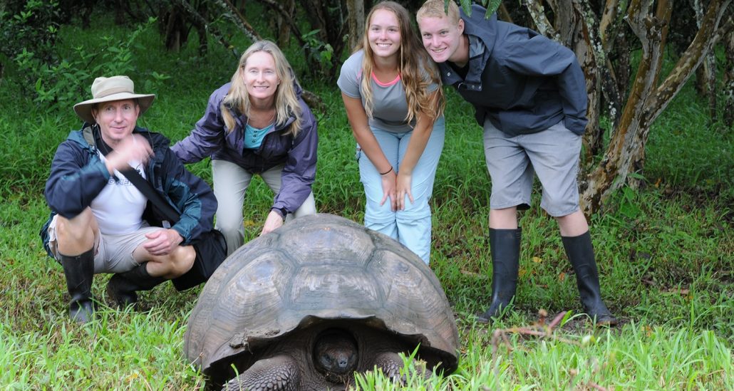 WorldStrides Travelers pose with a turtle at Tortuguero National Park in Costa Rica